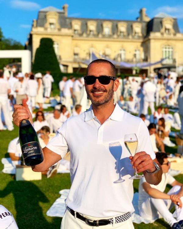 Kris Green holding a glass of champagne.