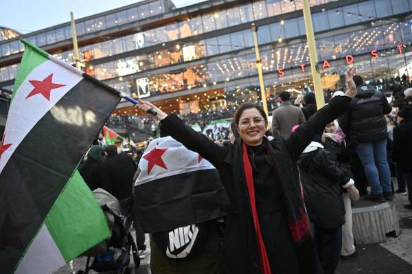 Members of the Syrian community celebrate in Stockholm after the fall of the Assad regime. Photograph: Jo<em></em>nas Ekstromer/TT news agency/AFP via Getty Images