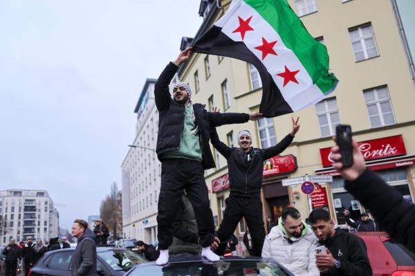 Syrians gather with flags in Berlin to celebrate the fall of the Assad regime. Photograph: Omer Messinger/Getty Images