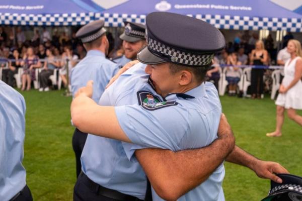 Two new officers hugging