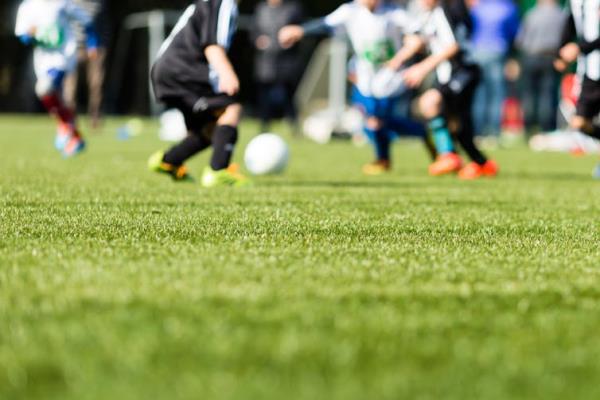 Out of focus image of a football team playing on a field