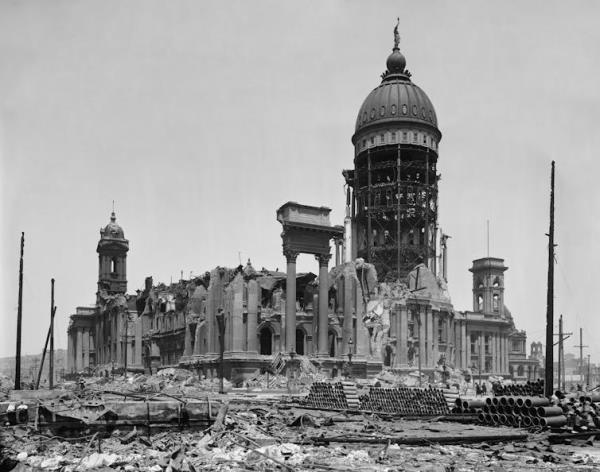 black and white photo of ruins of building with dome still intact