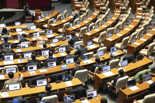 Members of the South Korean opposition wait for members of the ruling party to come back to the main chamber to vote on an impeachment motion against president Yoon Suk Yeol. Photograph: Woohae Cho/Bloomberg