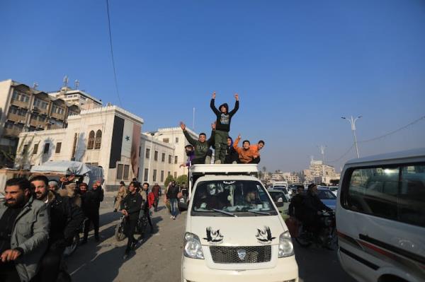 People celebrating the capture of the Syrian city of Hama by anti-government fighters. Photograph: Bakr Al Kassem/AFP