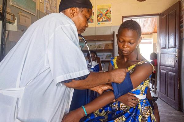 A woman has her blood pressure taken at a health clinic.