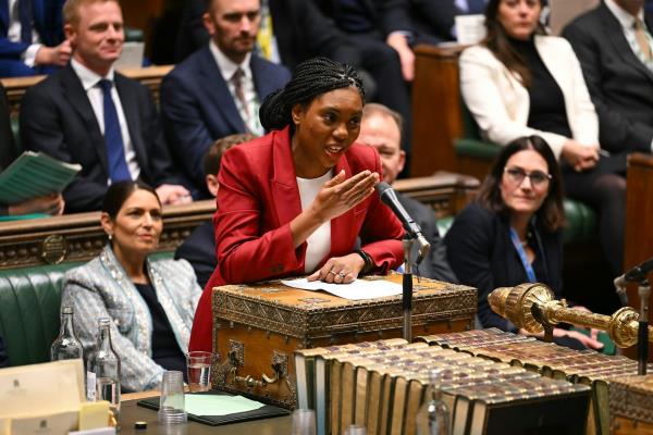 Kemi Badenoch speaking at the dispatch box in the commons, wearing a red suit