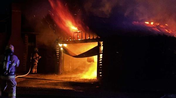 Garage fully involved in fire